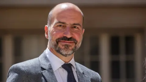EPA Dara Khosrowshahi arrives at a tech summit in Paris