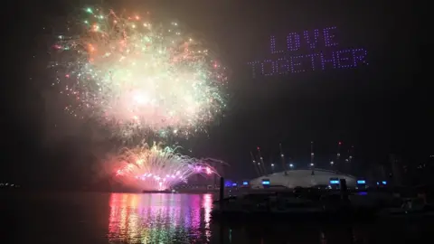 PA Media Fireworks and drones illuminate the night sky over the The O2 in London as they form a light display as London"s normal New Year"s Eve fireworks display was cancelled due to the coronavirus pandemic.