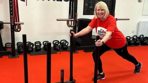 Annette Stimpson A women with blonde hair in a red top