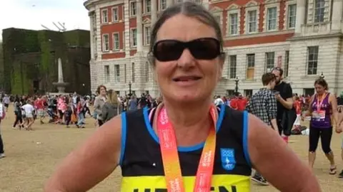 Helen McCann Helen McCann in her London Marathon running gear wearing sunglasses