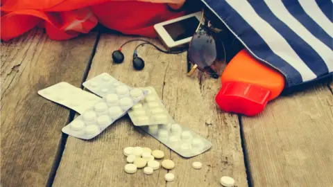 Getty Images Medicine with beach bag