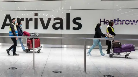 Getty Images Travellers arrive at Heathrow Terminal 5