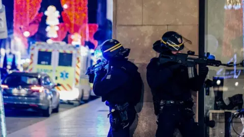 Getty Images French police stand guard near the scene of a shooting in Strasbourg, eastern France, 11 December 2018