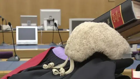 BBC barrister gown and wig in a courtroom