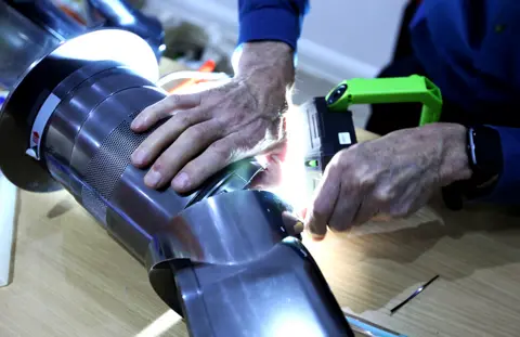 BBC Tony repairs a bladeless fan at the Fixing Factory in Camden, London