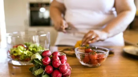 Overweight woman preparing healthy food