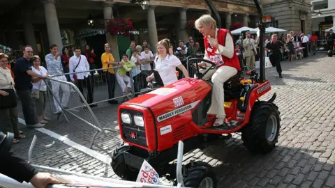 PA Media Nadine Dorries loses control of her tractor during an event to mark Red Tractor Week at Covent Garden, London 2007