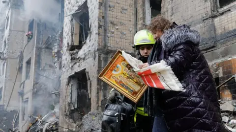 EPA People outside a missile-struck building in Kyiv