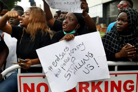 Reuters A protester holds a placard