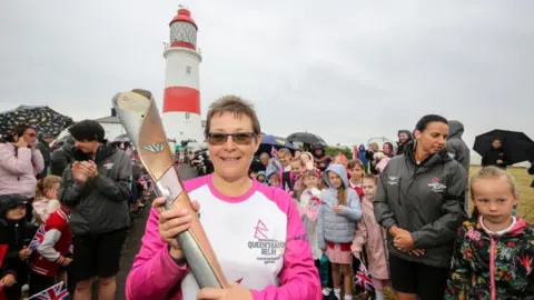 Getty Images Michelle Weedy holds the baton at Souter Lighthouse