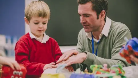 Getty Images Image of a teacher with a young boy