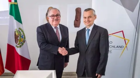 AFP The Mexican ambassador Rogelio Granguillhome and Rupert Gebhard of the archaeological State Collection in Munich shake hands