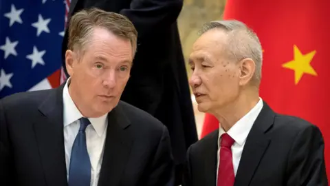 Reuters U.S. Trade Representative Robert Lighthizer, left, listens as Chinese Vice Premier Liu He talks while they line up for a group photo at the Diaoyutai State Guesthouse in Beijing, China February 15, 2019.