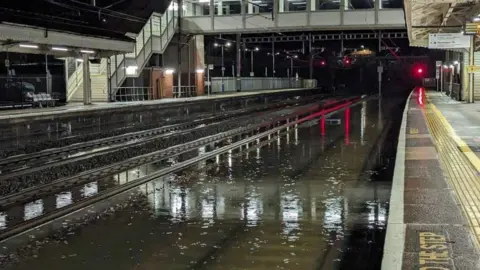 Richard Garvie Flooded tracks at a train station