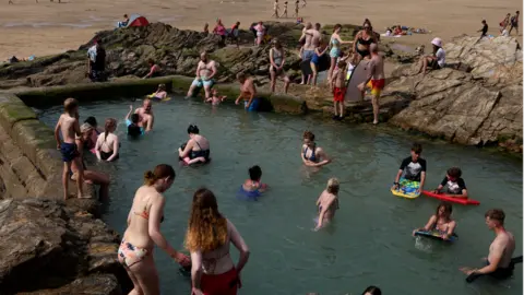 Reuters People in a pool at the beach in Perranporth, Cornwall