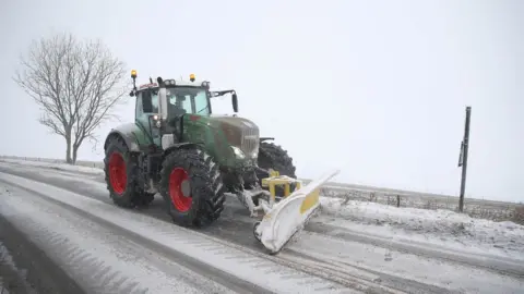PA A snow plough clears a road in Shaftesbury, Dorset.