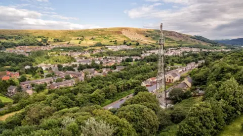 Getty Images A phone mast stands tall in a small Welsh town of Blaina