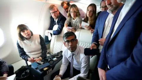 PA Media Rishi Sunak and press huddle on flight to Washington