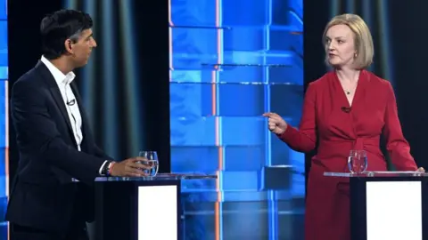 PA Media Rishi Sunak and Liz Truss on stage at a televised debate as part of the Tory leadership race