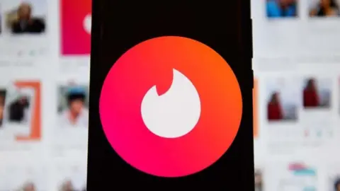 Getty Tinder's logo displaying on a mobile phone.