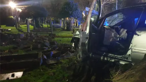 West Yorkshire Police Crashed car in a graveyard