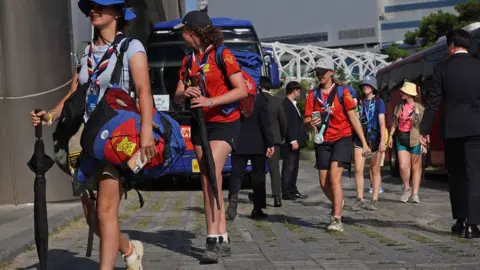 EPA British Scouts have started arriving at a hotel in Seoul after being taken by coach from the campsite