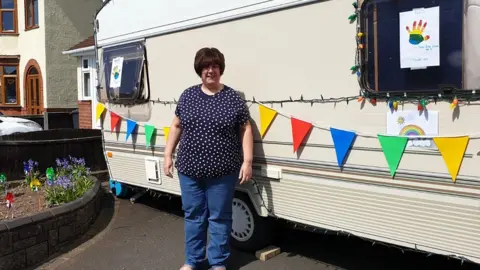 Sarah Link Sarah Link in front of her caravan