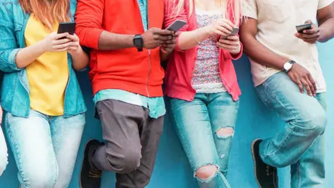 Getty Images Teenagers on mobile phones