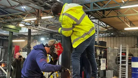 Two men building a cart