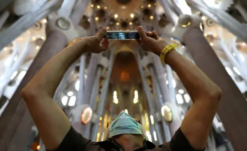Reuters Health workers, police officers and NGO staff visit the Sagrada Familia basilica with their families as it reopens following the coronavirus disease outbreak, in Barcelona, Spain, 4 July 2020