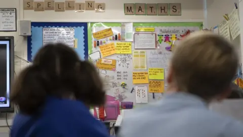 Danny Lawson/PA Two children in a school class