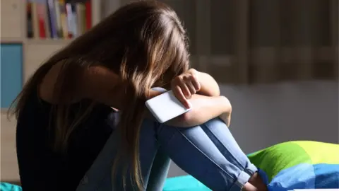 Getty Images A teenage girl with a smartphone