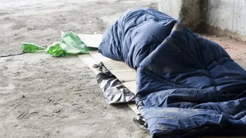 Getty Images A man sleeping rough on the streets.