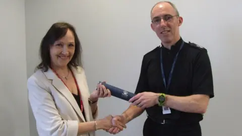 Police Scotland Sandra MacLean receiving her award from Ch Supt George Macdonald