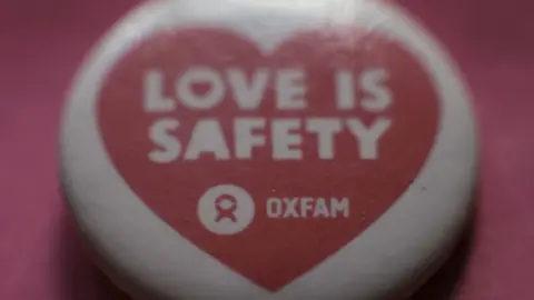 PA Oxfam badge
