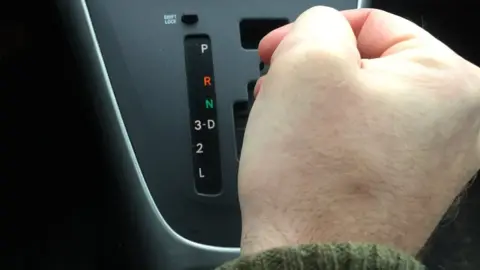 Getty Images Man using automatic gears