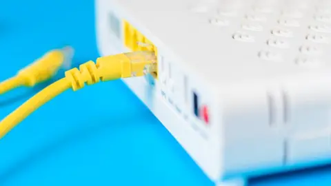 Getty Images Broadband cables in a router