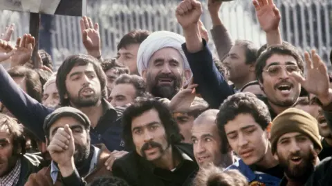 AFP A crowd welcomes Ayatollah Ruhollah Khomeini at Tehran's international airport after his return from exile (1 February 1979)
