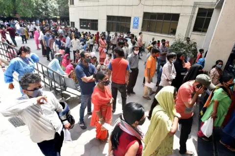 Getty Images People line up to get tested for Covid-19 during a special testing camp at Chacha Nehru hospital in Geeta colony, on April 16, 2021 in New Delhi, India.