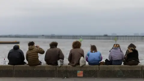 Getty Images young people sat on a wall on Southend seafront