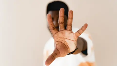 Getty Images man with his hand out