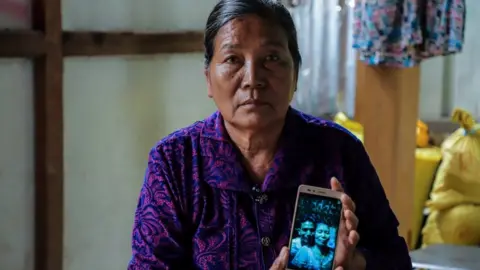 BBC Daw Mu Mu with a picture of her son