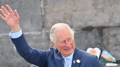 EPA Prince of Wales arrives to view stones which line the Donaghadee Harbour walls and were decorated with messages of hope by local people during the pan