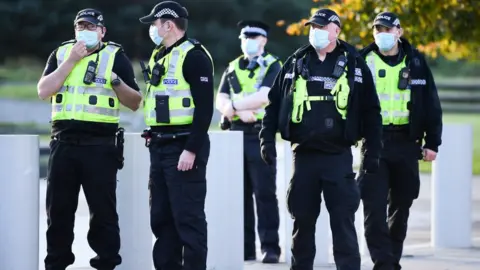 Getty Images Five police officers with masks