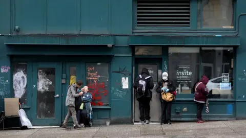 Clients wait outside of Insite, a supervised consumption site located in the Downtown Eastside (DTES) neighborhood, has injection booths where clients inject pre-obtained illicit drugs under the supervision of nurses and health care staff.