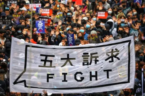 EPA People hold a banner reading "Fight" as they take part in an anti-government rally on New Year's Day in Hong Kong