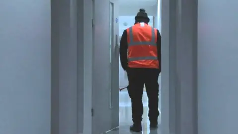 BBC Warden patrolling Albion Works with airhorn