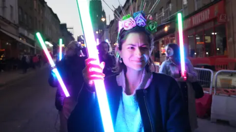 Bristol Nights Woman holding illuminated pole