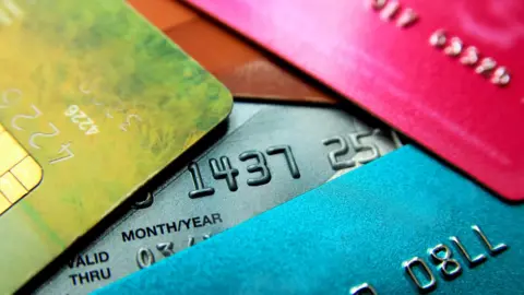 Getty Images Stack of multicoloured credit cards.