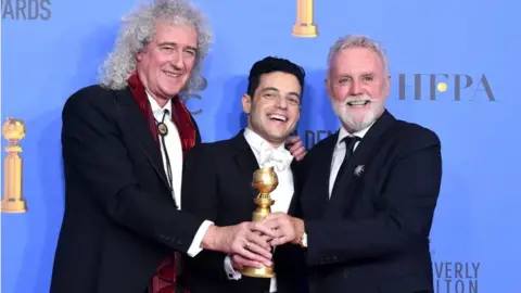 Getty Images Brian May and Roger Taylor of Queen with Rami Malek